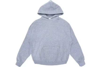 The Fear of God Essentials Graphic Pullover Hoodie in Grey epitomizes urban sophistication. Crafted with premium cotton, its relaxed fit ensures comfort